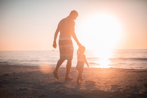 father with daughter on beach